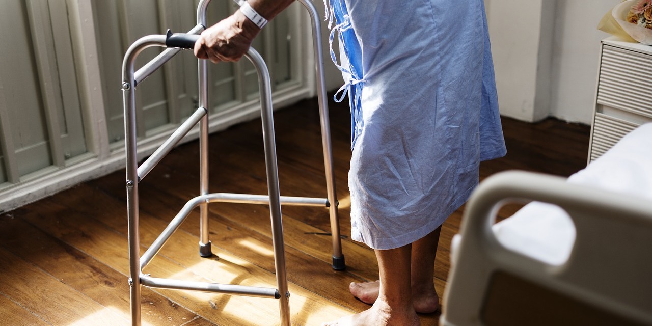 man-in-hospital-gown-using-walker-after-medical-negligence