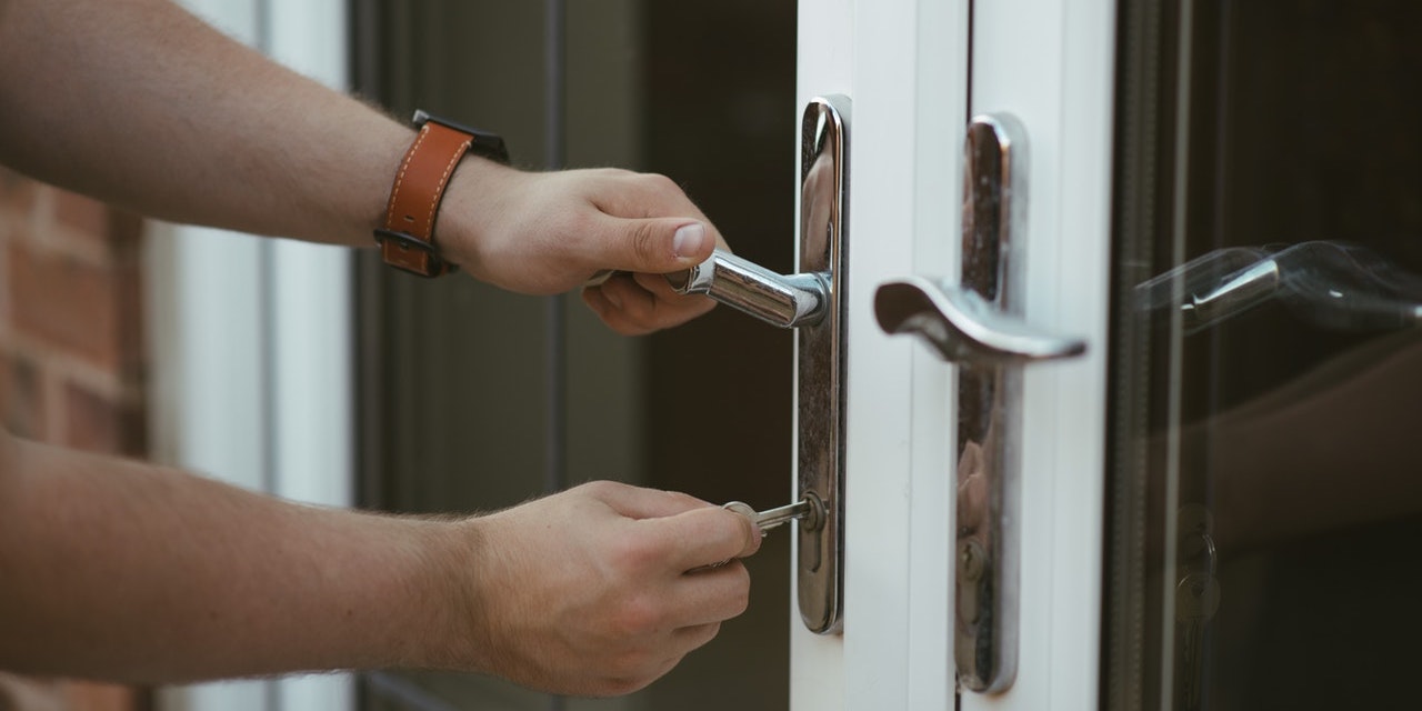 man-trying-to-unlock-patio-door