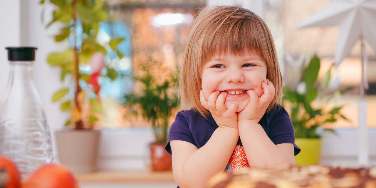 smiling-child-sat-at-kitchen-counter