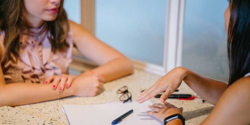 two-women-meeting-to-have-a-discussion-and-taking-notes